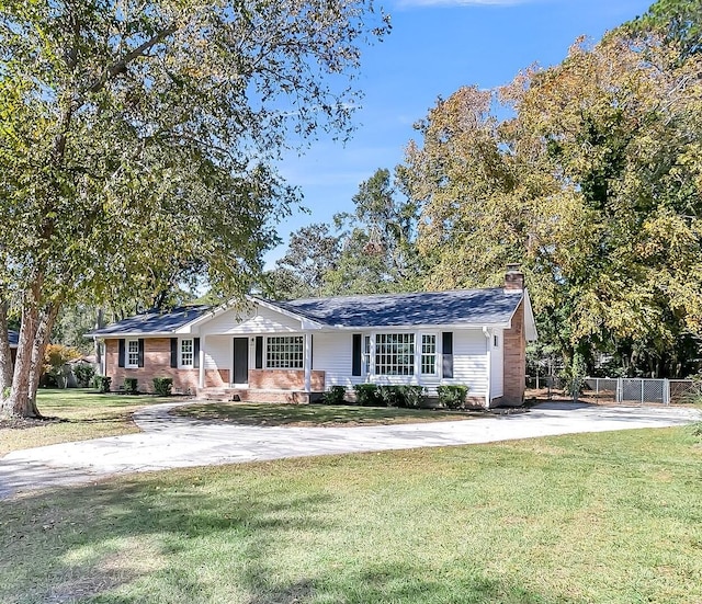 ranch-style home with a front lawn