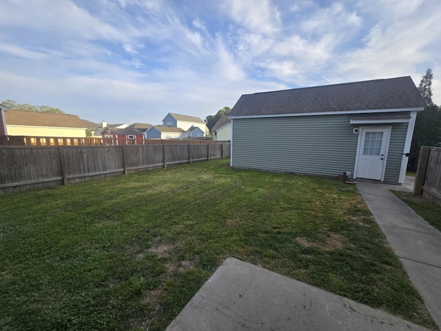 view of yard with an outdoor structure and a fenced backyard
