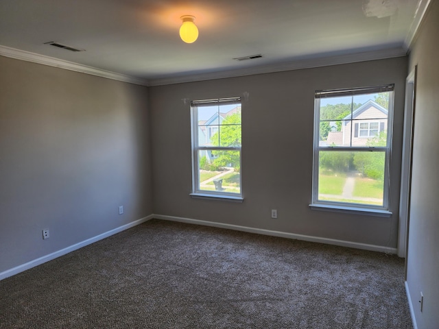 spare room featuring visible vents, crown molding, baseboards, and carpet floors