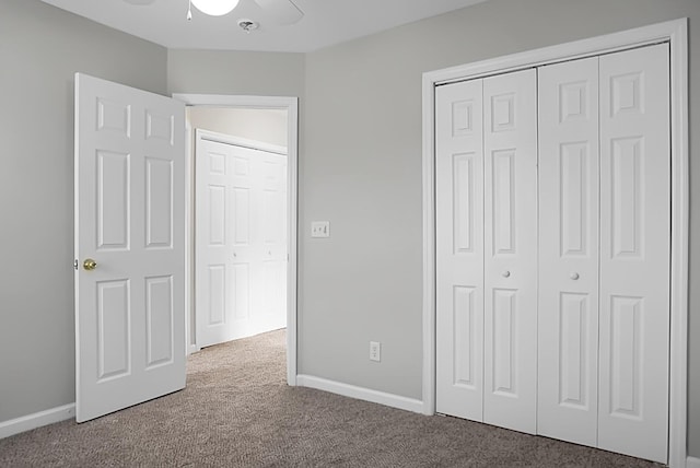 unfurnished bedroom with a closet, carpet flooring, ceiling fan, and baseboards