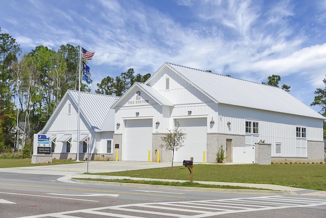 view of building exterior featuring driveway and an attached garage
