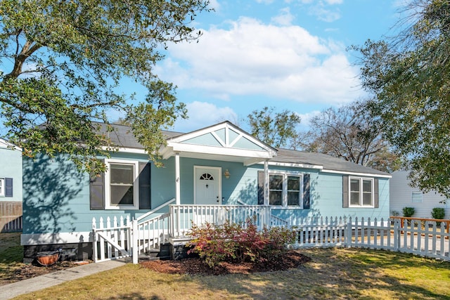 view of front facade with a porch and a fenced front yard