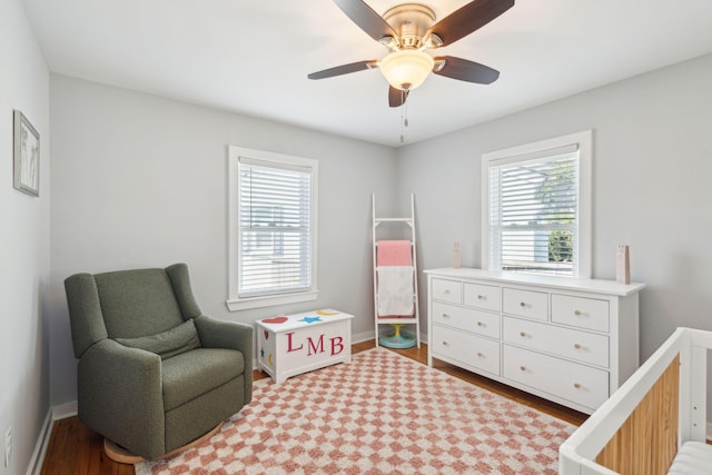 bedroom featuring ceiling fan, wood finished floors, and baseboards