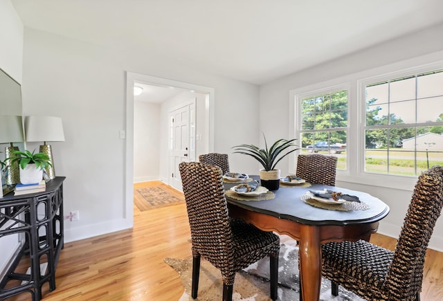 dining room with light wood-style floors and baseboards