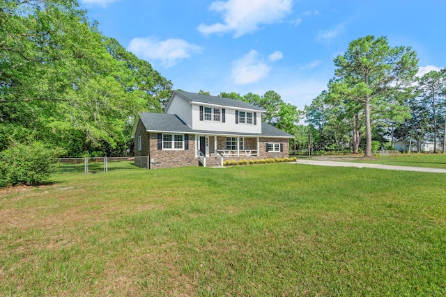 view of front of home with a front yard and fence