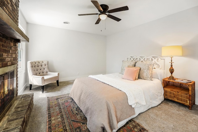 bedroom featuring visible vents, baseboards, carpet floors, a fireplace, and a ceiling fan