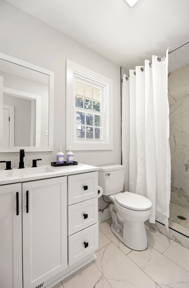 full bath with toilet, marble finish floor, a stall shower, and vanity