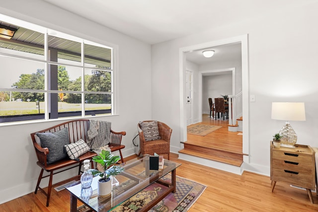 sitting room featuring visible vents, wood finished floors, and baseboards