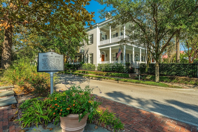 view of front facade with a balcony and fence