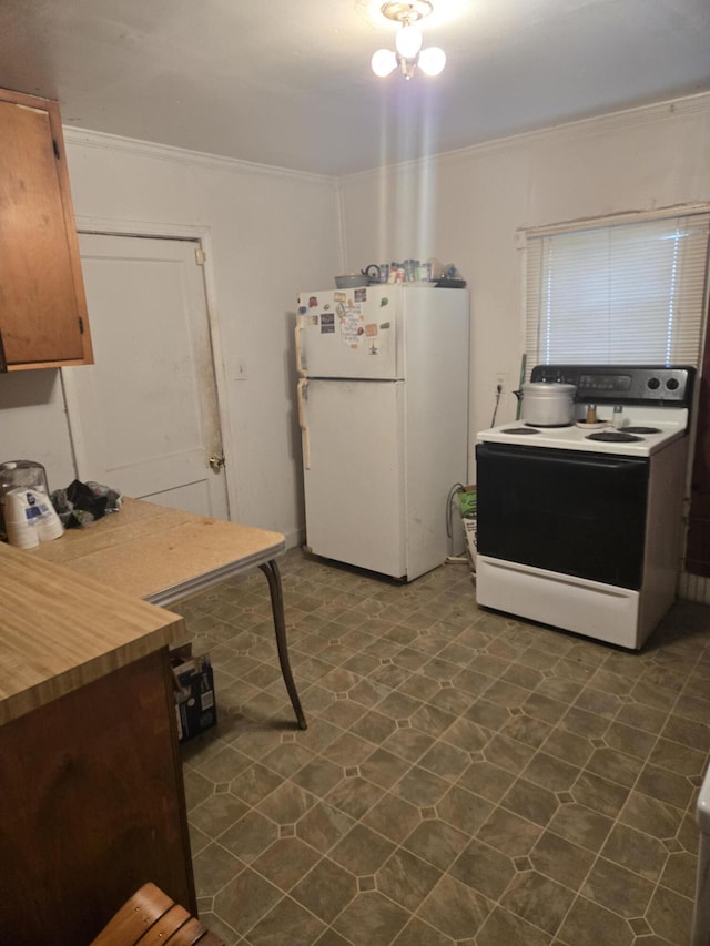 kitchen featuring crown molding and white appliances