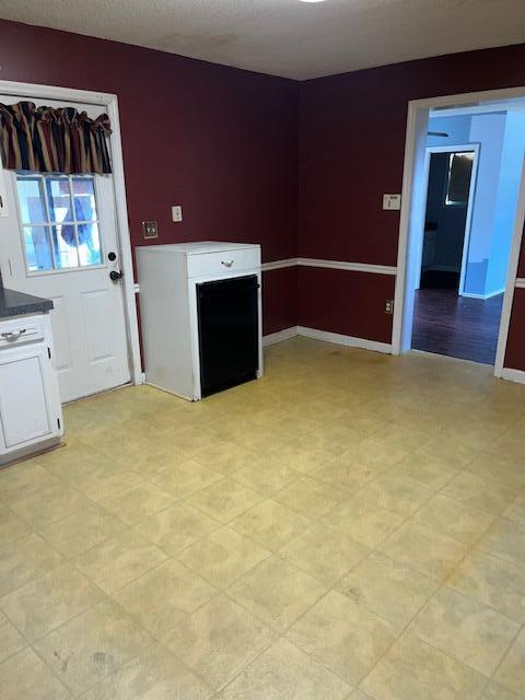 interior space featuring light floors and baseboards