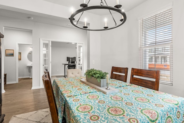 dining space featuring an inviting chandelier and dark hardwood / wood-style floors