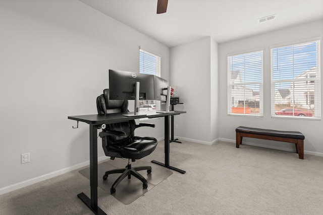 carpeted office featuring ceiling fan