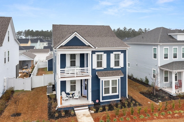 view of front facade with cooling unit, a porch, and a balcony