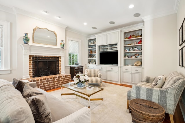 living area featuring crown molding, light wood-style flooring, recessed lighting, and a brick fireplace