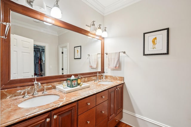 full bathroom with double vanity, a sink, and ornamental molding
