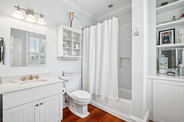 bathroom featuring ornamental molding, wood finished floors, toilet, vanity, and shower / bath combo with shower curtain