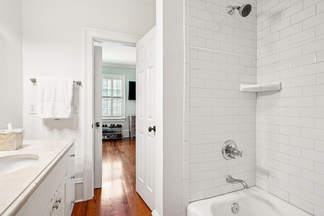 bathroom featuring vanity,  shower combination, and wood finished floors