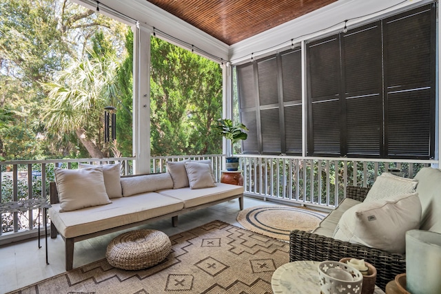 sunroom featuring plenty of natural light and an outdoor living space