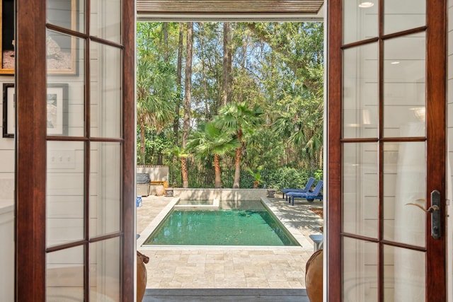 view of swimming pool with french doors