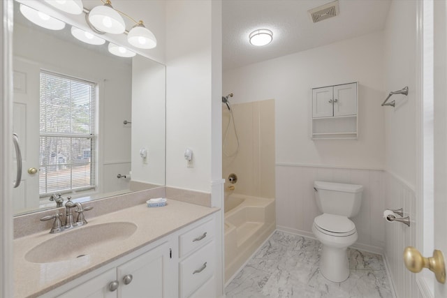 full bathroom featuring vanity, bathtub / shower combination, a textured ceiling, and toilet