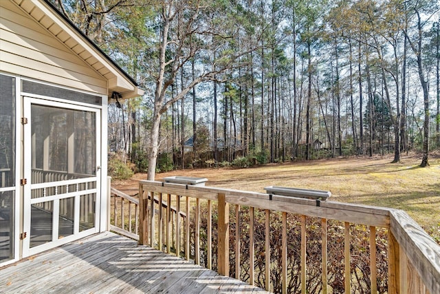 wooden terrace featuring a lawn