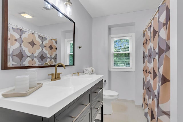 bathroom with tile patterned flooring, toilet, and vanity