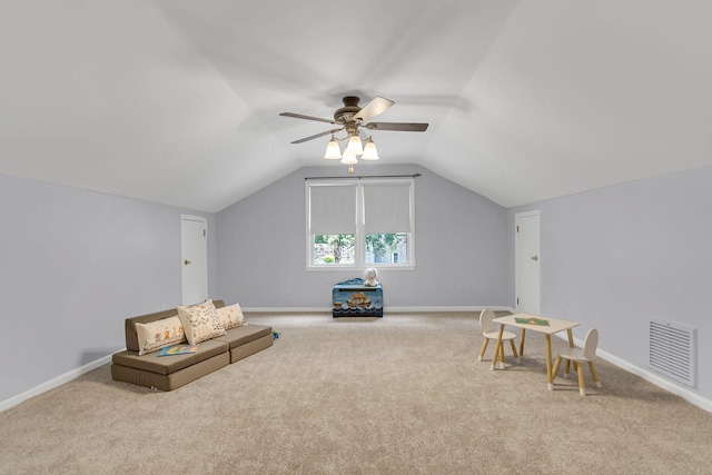 interior space with lofted ceiling, ceiling fan, and carpet floors