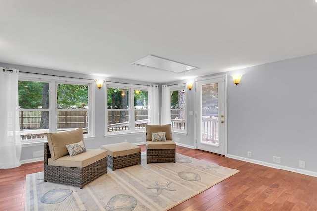 sitting room featuring a wealth of natural light and hardwood / wood-style flooring