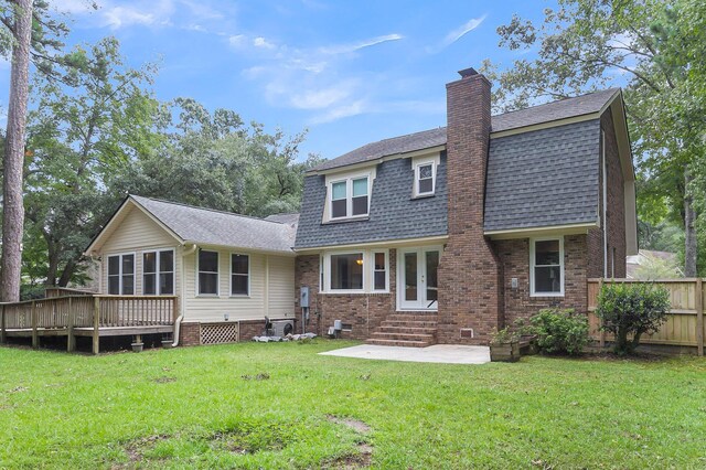 back of property featuring a yard and a deck