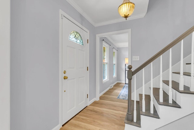 foyer featuring light hardwood / wood-style floors and crown molding