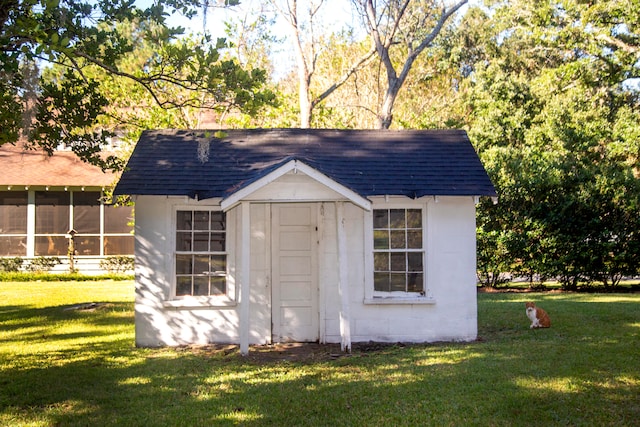 view of outbuilding featuring a lawn