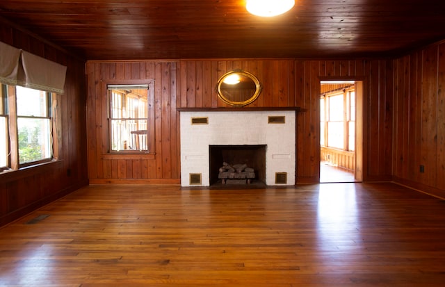 unfurnished living room featuring wood ceiling, wood walls, and dark hardwood / wood-style flooring