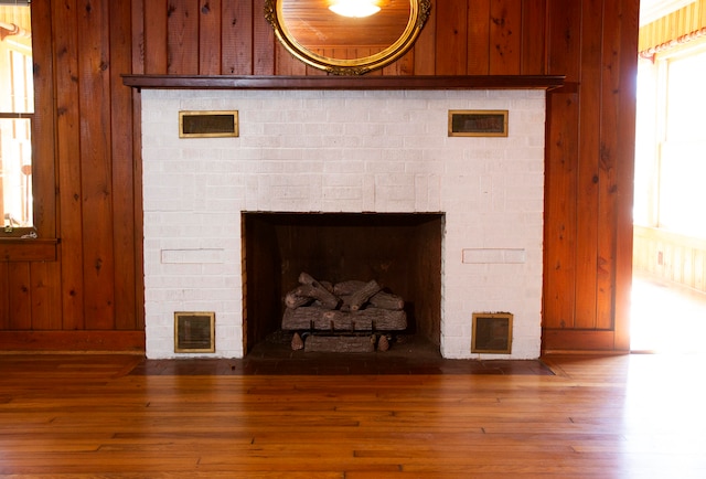 room details with wooden walls and hardwood / wood-style flooring