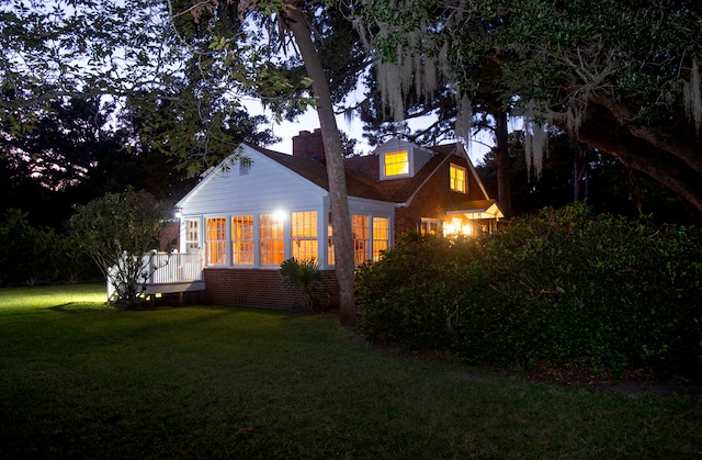 view of side of home with a yard