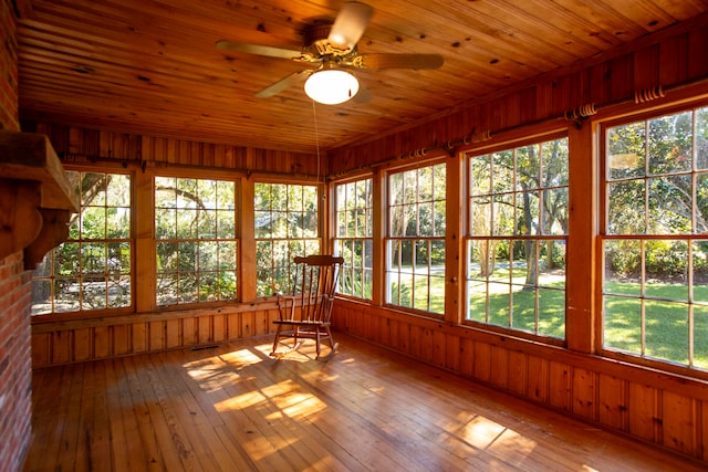 unfurnished sunroom with wooden ceiling and ceiling fan