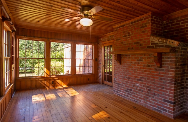 unfurnished sunroom with ceiling fan and wooden ceiling