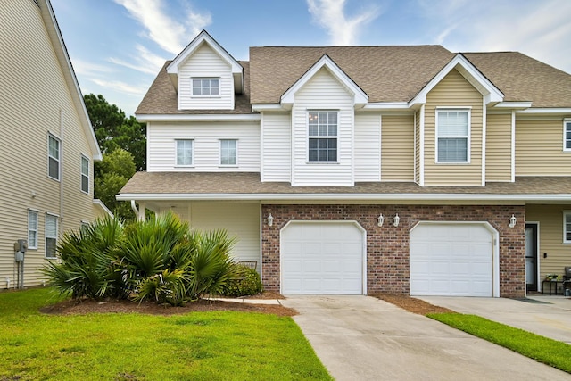 townhome / multi-family property with brick siding, concrete driveway, a front lawn, and a shingled roof