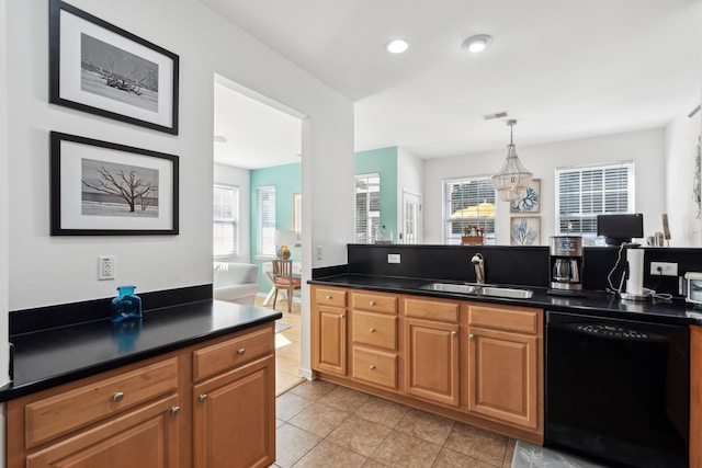 kitchen with visible vents, a sink, dark countertops, light tile patterned flooring, and dishwasher