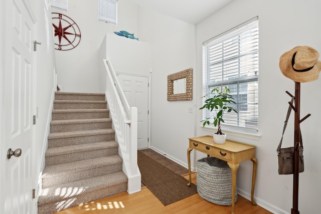 stairway with baseboards and wood finished floors