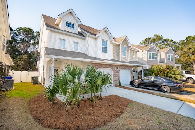 view of front of property with brick siding, fence, central AC, a garage, and driveway