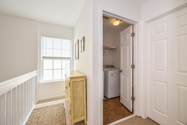 hallway featuring carpet flooring and washer / dryer