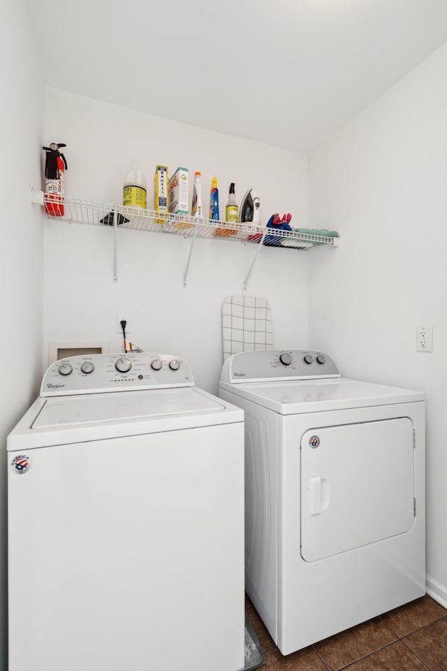 washroom featuring laundry area, dark tile patterned floors, and separate washer and dryer