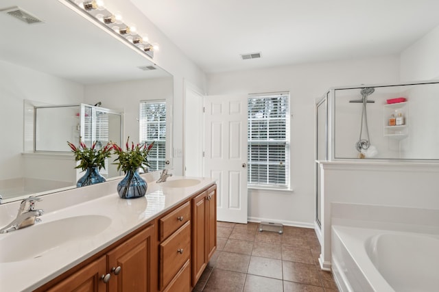 bathroom featuring a sink, visible vents, and a stall shower