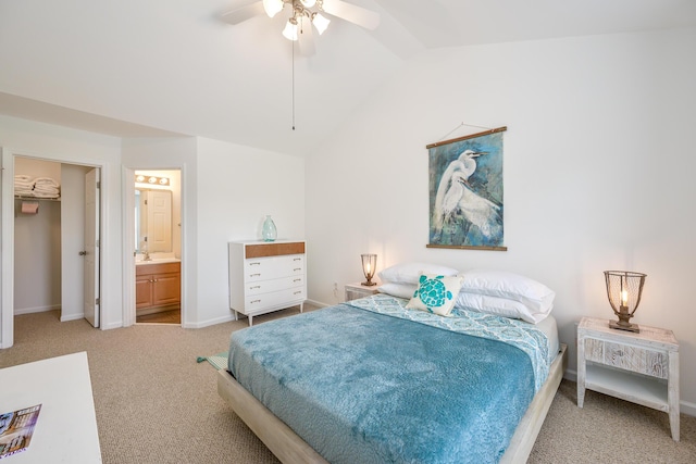 carpeted bedroom featuring ceiling fan, lofted ceiling, baseboards, and connected bathroom