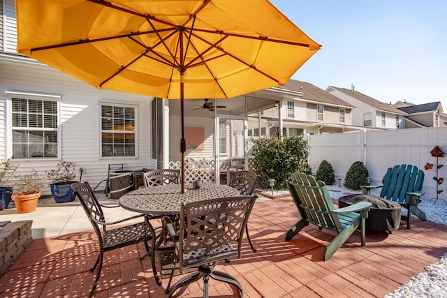 wooden terrace with outdoor dining space, a patio, and fence