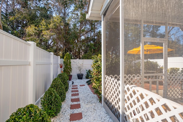 view of yard featuring a fenced backyard and a sunroom