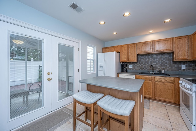 1401 Elm Hall Cir, Summerville, SC 29483 - kitchen with white appliances, a sink, recessed lighting, light tile patterned flooring, and brown cabinetry