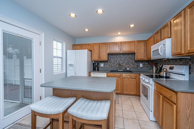 1401 Elm Hall Cir, Summerville, SC 29483 - kitchen with white appliances, a sink, backsplash, a center island, and recessed lighting