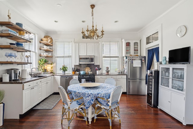 kitchen featuring white cabinets, sink, tasteful backsplash, dark hardwood / wood-style flooring, and stainless steel appliances